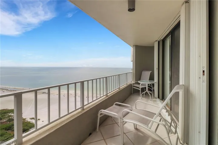 Balcony with a water view and a beach view