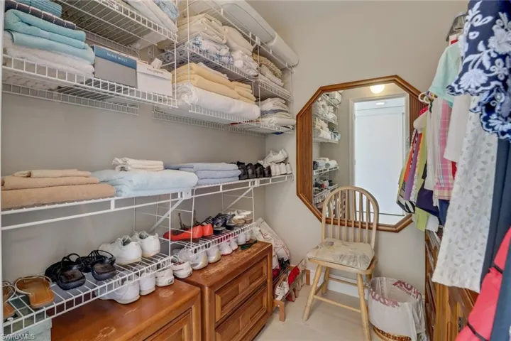 Bathroom featuring tile floors, vanity, and a tile shower