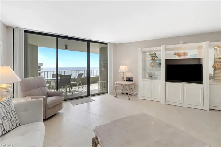 Tiled living room featuring expansive windows