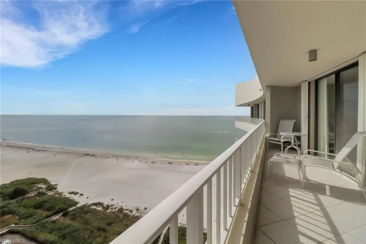 Balcony with a water view and a beach view