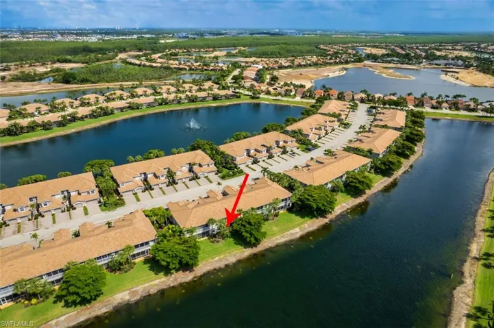 Aerial perspective of suburban area featuring a large body of water