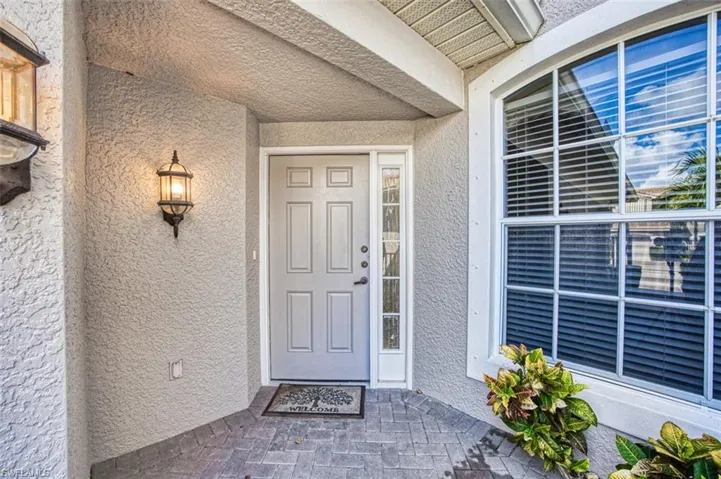 Entrance to property with stucco siding