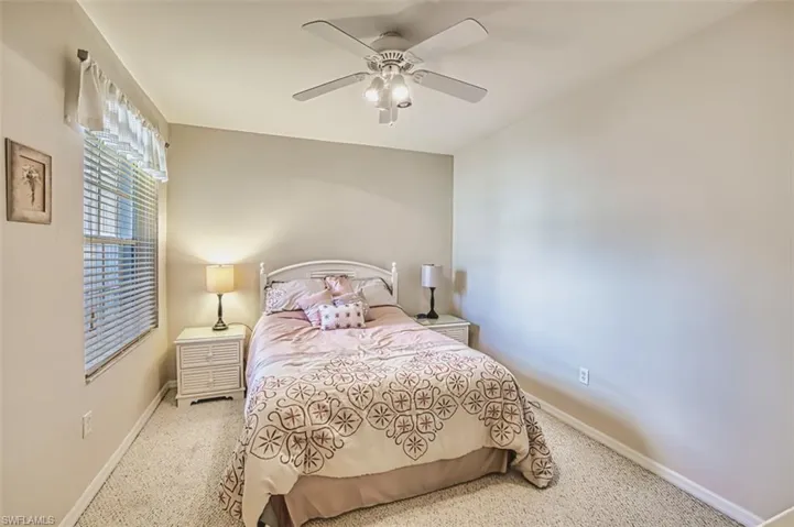 Bedroom featuring baseboards, ceiling fan, and carpet