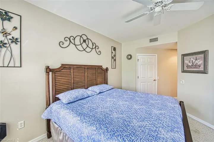 Bedroom with carpet flooring, baseboards, and ceiling fan