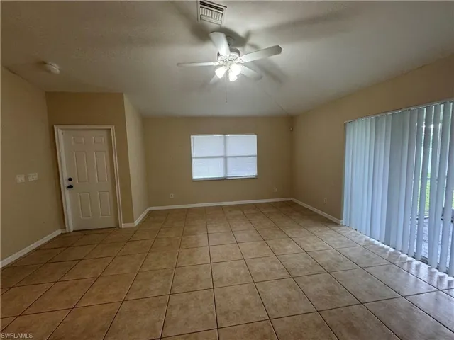 Spare room featuring ceiling fan and light tile patterned flooring