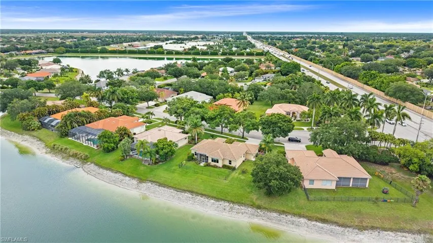 Aerial perspective showcasing multiple properties with water frontage