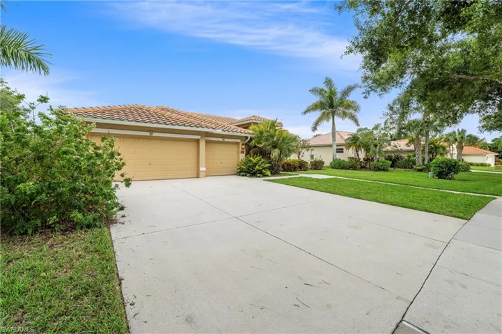 Exterior featuring a tile roof, stucco finish, and a two-car garage