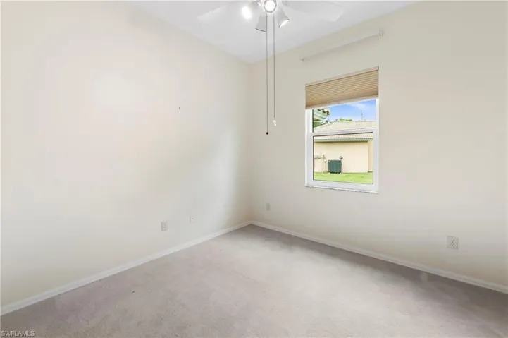 Neutral wall tones enhance this room with a ceiling fan, carpet flooring, a window with horizontal blinds, and white trim
