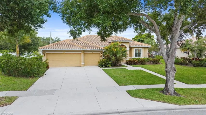 Exterior residence featuring a two-car garage, concrete driveway, and front walk