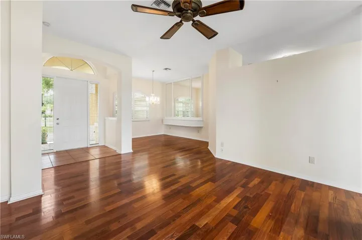 Warm wood-finish flooring extending from the entryway