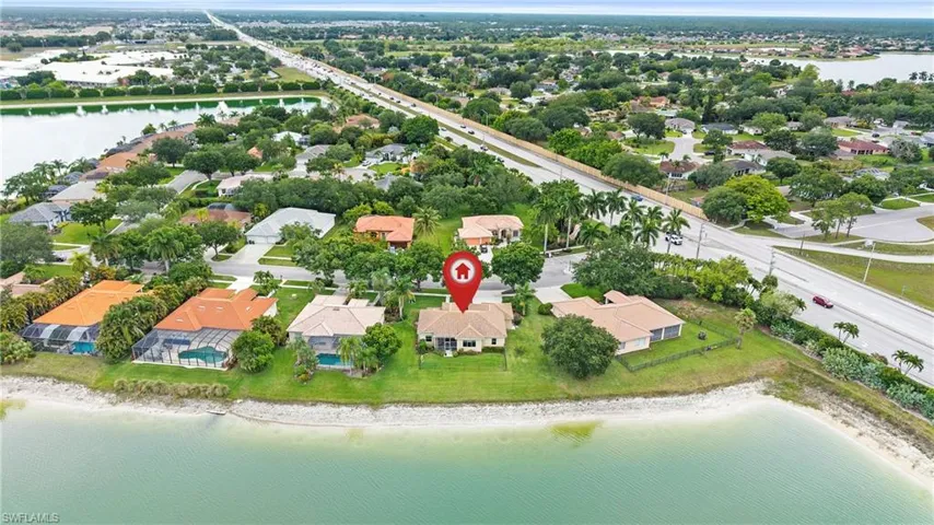 Aerial perspective showcasing multiple properties with water frontage