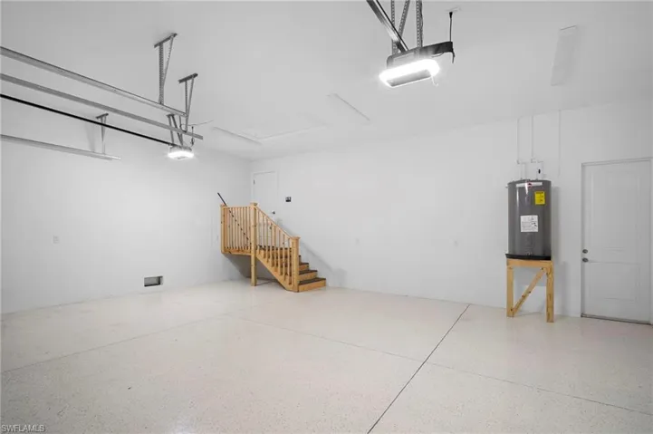Garage with water heater and a garage door opener