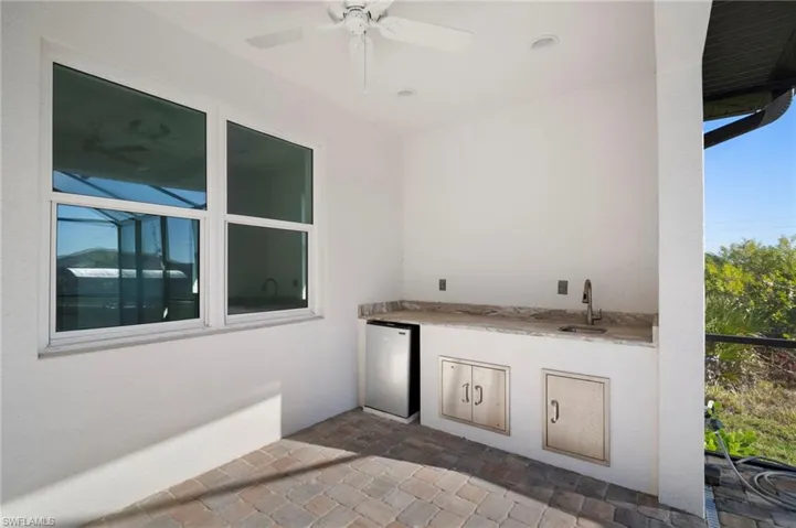 View of patio / terrace with an outdoor kitchen and ceiling fan