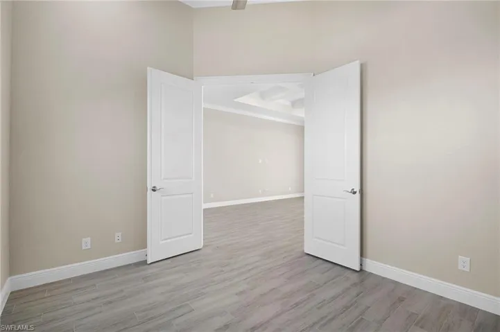 Unfurnished room featuring baseboards and light wood finished floors