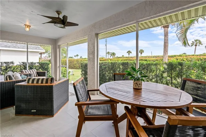 Sunroom with ceiling fan, outdoor dining area, an outdoor living space, and tile patterned flooring