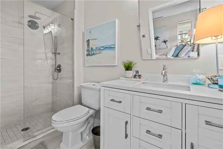 Bathroom with vanity and a tile shower