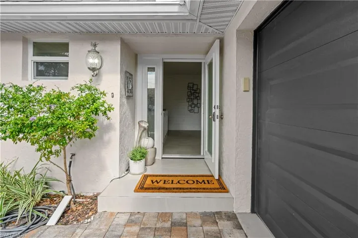 View of exterior entry with stucco siding