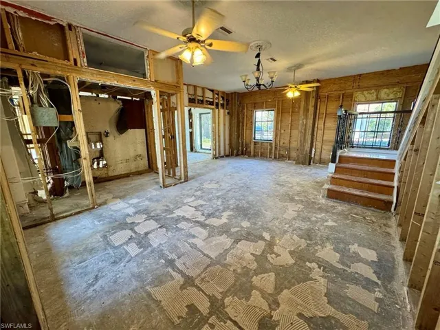 Unfurnished living room with ceiling fan