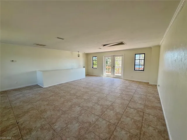 Spare room with crown molding and french doors