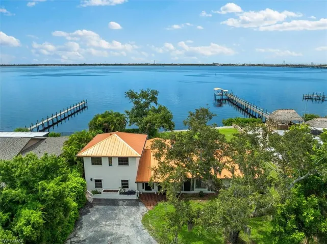Birds eye view of property featuring a water view