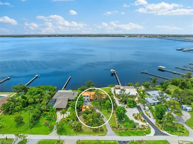 Birds eye view of property with a water view