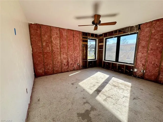 Carpeted spare room with ceiling fan