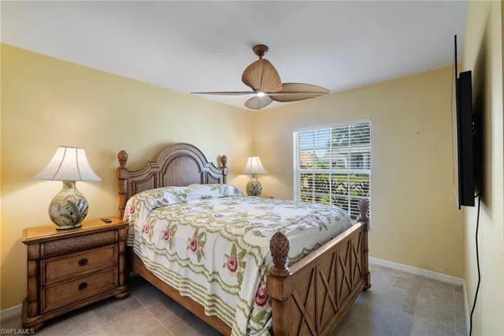 Bedroom with tile patterned flooring and ceiling fan