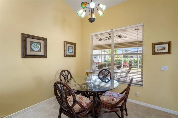 Tiled dining space with a notable chandelier