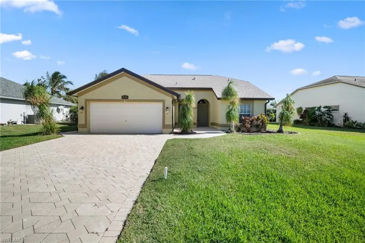 Single story home with a garage, central air condition unit, and a front yard