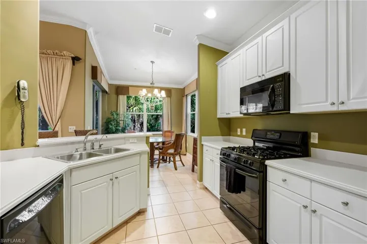 The kitchen is generously sized and offers ample cabinetry and workspace.