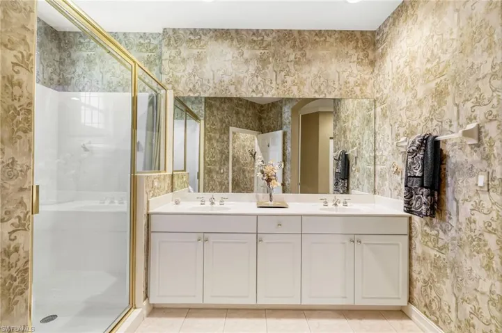 The primary ensuite bathroom includes a spacious shower, dual vanity and private commode.