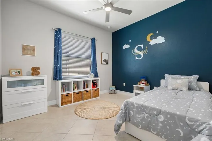 Bedroom with light tile flooring and ceiling fan