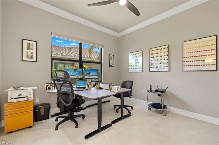 Office with ornamental molding, ceiling fan, and light tile floors