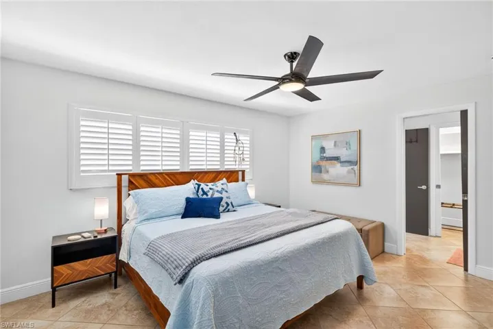 Bedroom with a ceiling fan and light tile patterned floors