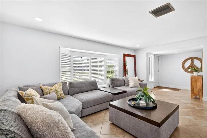 Living area featuring recessed lighting and light tile patterned floors