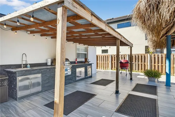 View of patio featuring area for grilling and a sink