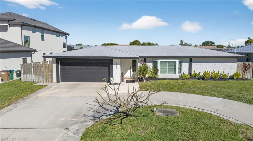 Single story home featuring driveway and an attached garage