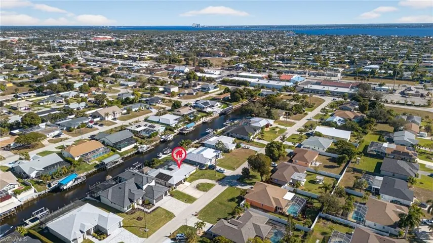 View of property location with a large body of water and nearby suburban area