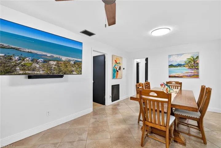 Dining space featuring a ceiling fan and light tile patterned floors