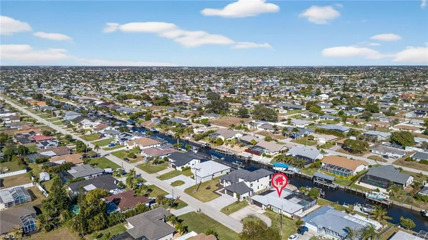 Aerial perspective of suburban area with a nearby body of water