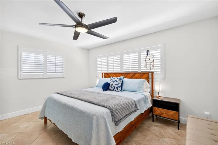 Bedroom featuring ceiling fan and light tile patterned flooring