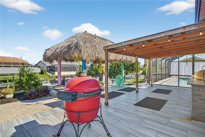 Deck with glass enclosure, a patio, and an outdoor pool