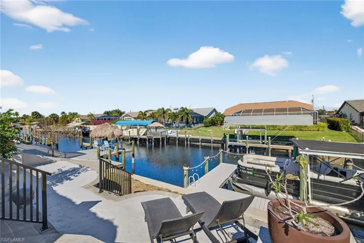 Dock featuring a water view, a residential view, and boat lift