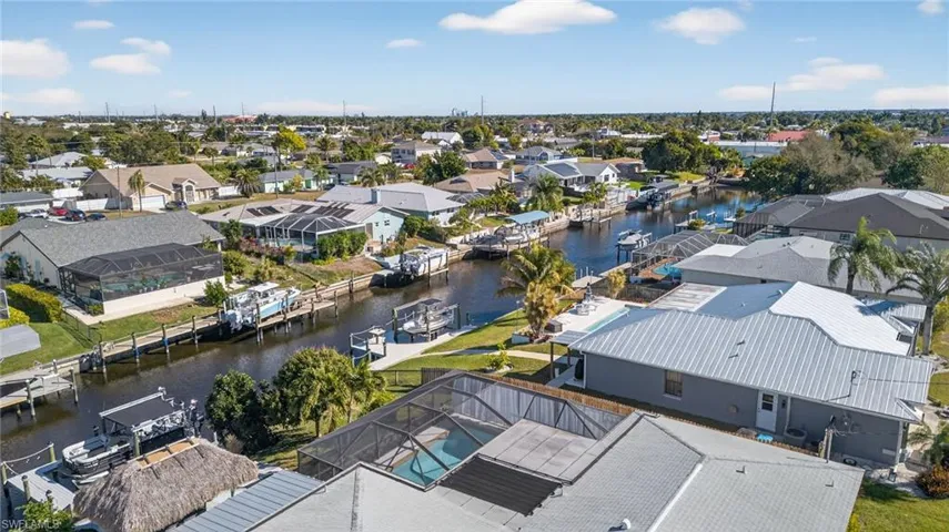 Aerial view of residential area featuring a nearby body of water
