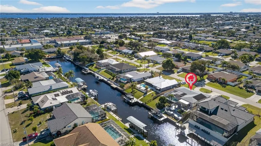 View of property location featuring a nearby body of water and nearby suburban area
