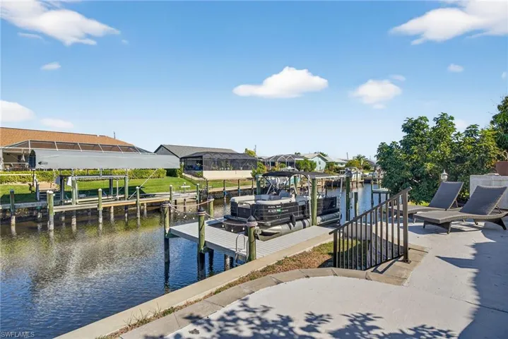 Dock area with a water view and boat lift