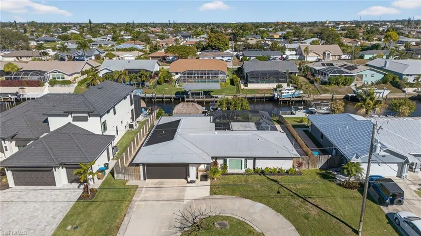 Aerial perspective of suburban area with a nearby body of water
