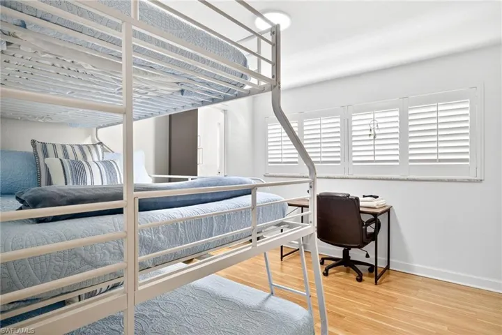 Bedroom with light wood-type flooring and baseboards