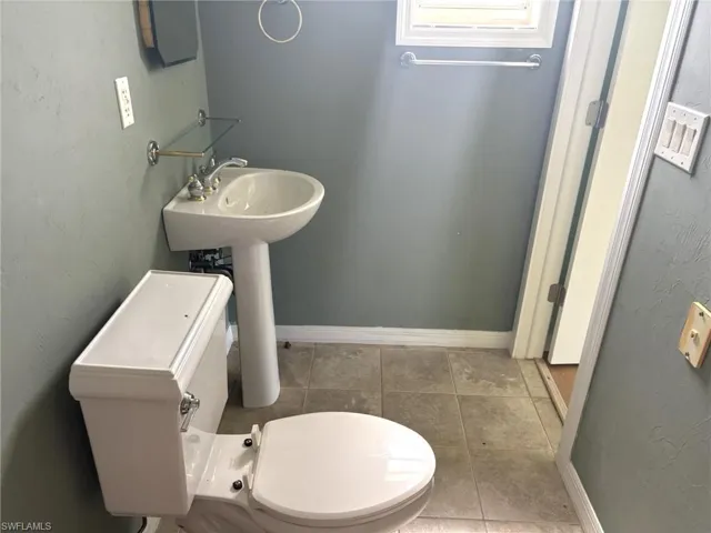 PRIMARY BATHROOM WITH TILED SHOWER AND PEDESTAL SINK