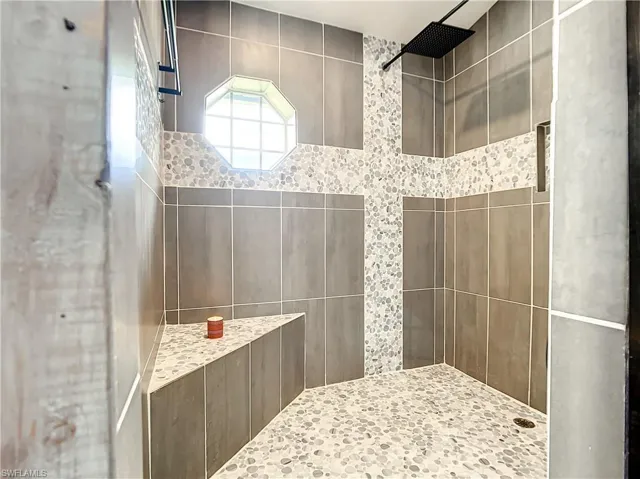 Full bath featuring a tile shower